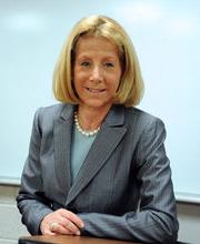 Dr. Phyllis Gimbel at the podium in a classroom